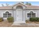 House exterior featuring a white front door and arched windows at 4181 Sw 111Th Pl, Ocala, FL 34476