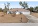 House exterior with a front yard and driveway at 4181 Sw 111Th Pl, Ocala, FL 34476