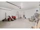 Spacious garage featuring ample storage, speckled floor, and lawn equipment at 4181 Sw 111Th Pl, Ocala, FL 34476