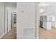 Hallway leading to an open kitchen with stainless steel appliances and modern light fixtures at 4181 Sw 111Th Pl, Ocala, FL 34476