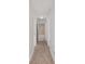 Hallway with carpet floor and view into the Primary bathroom at 4181 Sw 111Th Pl, Ocala, FL 34476