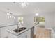 Stylish kitchen featuring a center island, white cabinetry, granite countertops, and stainless steel appliances at 4181 Sw 111Th Pl, Ocala, FL 34476