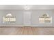 Bright living area featuring modern lighting, hardwood floors, and two arched windows with a view of the outdoors at 4181 Sw 111Th Pl, Ocala, FL 34476