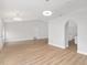 Open-concept living area featuring light walls, wood-look floors, and vaulted ceilings at 4181 Sw 111Th Pl, Ocala, FL 34476