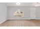 Open living space with large arched window and hardwood floors at 4181 Sw 111Th Pl, Ocala, FL 34476