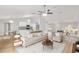 Bright and airy living room featuring an open floor plan, modern furnishings, and wood-look flooring at 4181 Sw 111Th Pl, Ocala, FL 34476
