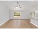 Spacious living room with wood floors, bright natural light, and an adjacent kitchen island at 4181 Sw 111Th Pl, Ocala, FL 34476