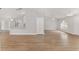 Bright, open living space with wood-look flooring, adjacent to the kitchen and dining area at 4181 Sw 111Th Pl, Ocala, FL 34476