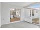 Enclosed patio showcases the bright kitchen, featuring granite countertops and modern appliances, through sliding glass doors at 4181 Sw 111Th Pl, Ocala, FL 34476