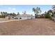 Side yard of the house with dry grass and trees at 4181 Sw 111Th Pl, Ocala, FL 34476