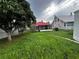Well manicured backyard with large tree, a screened-in porch and a large yard at 433 Pennsylvania Ave, St Cloud, FL 34769