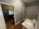 Bathroom featuring gray walls, marble tiled shower, and modern sink at 433 Pennsylvania Ave, St Cloud, FL 34769