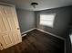 Clean bedroom featuring modern flooring, neutral paint, and a single window at 433 Pennsylvania Ave, St Cloud, FL 34769