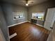 Comfortable bedroom featuring modern flooring, neutral paint, and two windows at 433 Pennsylvania Ave, St Cloud, FL 34769