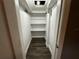 Walk-in closet with built-in shelving and new hardwood floors at 433 Pennsylvania Ave, St Cloud, FL 34769