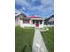 Charming home with a red roof, red door, and a well-manicured front yard at 433 Pennsylvania Ave, St Cloud, FL 34769
