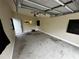 Empty garage with a concrete floor and overhead lighting at 433 Pennsylvania Ave, St Cloud, FL 34769