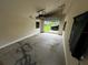 Empty garage with a partially open door to the backyard at 433 Pennsylvania Ave, St Cloud, FL 34769