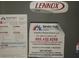 Lennox Elite AC unit label with service contact information at 4702 Greycliff Prairie Dr, Kissimmee, FL 34758