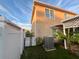 Air conditioning unit next to the house and a white fence at 4702 Greycliff Prairie Dr, Kissimmee, FL 34758