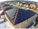 House with solar panels on roof, viewed from above at 4702 Greycliff Prairie Dr, Kissimmee, FL 34758