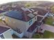 House with solar panels on roof, viewed from above at 4702 Greycliff Prairie Dr, Kissimmee, FL 34758