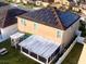 House with solar panels, screened patio, and pergola at 4702 Greycliff Prairie Dr, Kissimmee, FL 34758