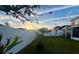Spacious backyard with grassy area and white fence at 4702 Greycliff Prairie Dr, Kissimmee, FL 34758