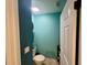 Small teal bathroom with a toilet and pedestal sink at 4702 Greycliff Prairie Dr, Kissimmee, FL 34758