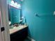 Small bathroom boasts teal walls and modern vanity at 4702 Greycliff Prairie Dr, Kissimmee, FL 34758
