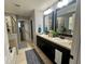 Elegant bathroom with double sinks and large mirrors at 4702 Greycliff Prairie Dr, Kissimmee, FL 34758