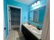 Bathroom with double sinks and teal walls at 4702 Greycliff Prairie Dr, Kissimmee, FL 34758