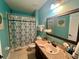 Clean bathroom with teal walls and updated vanity at 4702 Greycliff Prairie Dr, Kissimmee, FL 34758