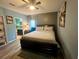 Bedroom with a queen bed and en-suite bathroom access at 4702 Greycliff Prairie Dr, Kissimmee, FL 34758