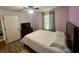 Bedroom with wood-look floors, large bed and ceiling fan at 4702 Greycliff Prairie Dr, Kissimmee, FL 34758
