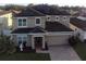 Two story house with solar panels and a fountain at 4702 Greycliff Prairie Dr, Kissimmee, FL 34758
