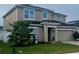 Two-story house with solar panels and landscaped front yard at 4702 Greycliff Prairie Dr, Kissimmee, FL 34758