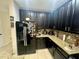 Modern kitchen with dark wood cabinets at 4702 Greycliff Prairie Dr, Kissimmee, FL 34758