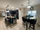 Modern kitchen with dark cabinets and an island with seating at 4702 Greycliff Prairie Dr, Kissimmee, FL 34758