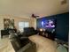 Spacious living room with a large TV and comfortable seating at 4702 Greycliff Prairie Dr, Kissimmee, FL 34758