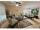 Bright living room features a comfy sofa, armchair, and dining area at 4702 Greycliff Prairie Dr, Kissimmee, FL 34758