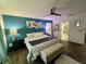 Large bedroom with teal accent wall and ensuite bathroom at 4702 Greycliff Prairie Dr, Kissimmee, FL 34758