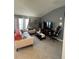 Living room featuring a beige couch, a large TV, and a gaming chair at 503 Summer Grove Ln, Haines City, FL 33844