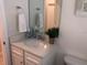 Clean bathroom with single vanity and large mirror at 5465 Misty Oak Cir, Davenport, FL 33837