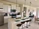 Modern kitchen featuring white cabinets, stainless steel appliances, and a large island with seating at 5465 Misty Oak Cir, Davenport, FL 33837