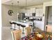 Bright kitchen with white cabinets, an island, and stainless steel appliances at 5465 Misty Oak Cir, Davenport, FL 33837