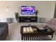 Gathering-friendly living room with a large TV, comfortable seating, and game tables at 5465 Misty Oak Cir, Davenport, FL 33837