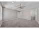 Spacious bedroom featuring carpet floors, ceiling fan, and access to closet at 575 Tupelo Cir, Davenport, FL 33897