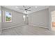 Spacious bedroom featuring hard wood floors, ceiling fan, and large windows for natural light at 575 Tupelo Cir, Davenport, FL 33897