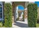 Elegant entryway with stone arch and lush landscaping at 575 Tupelo Cir, Davenport, FL 33897